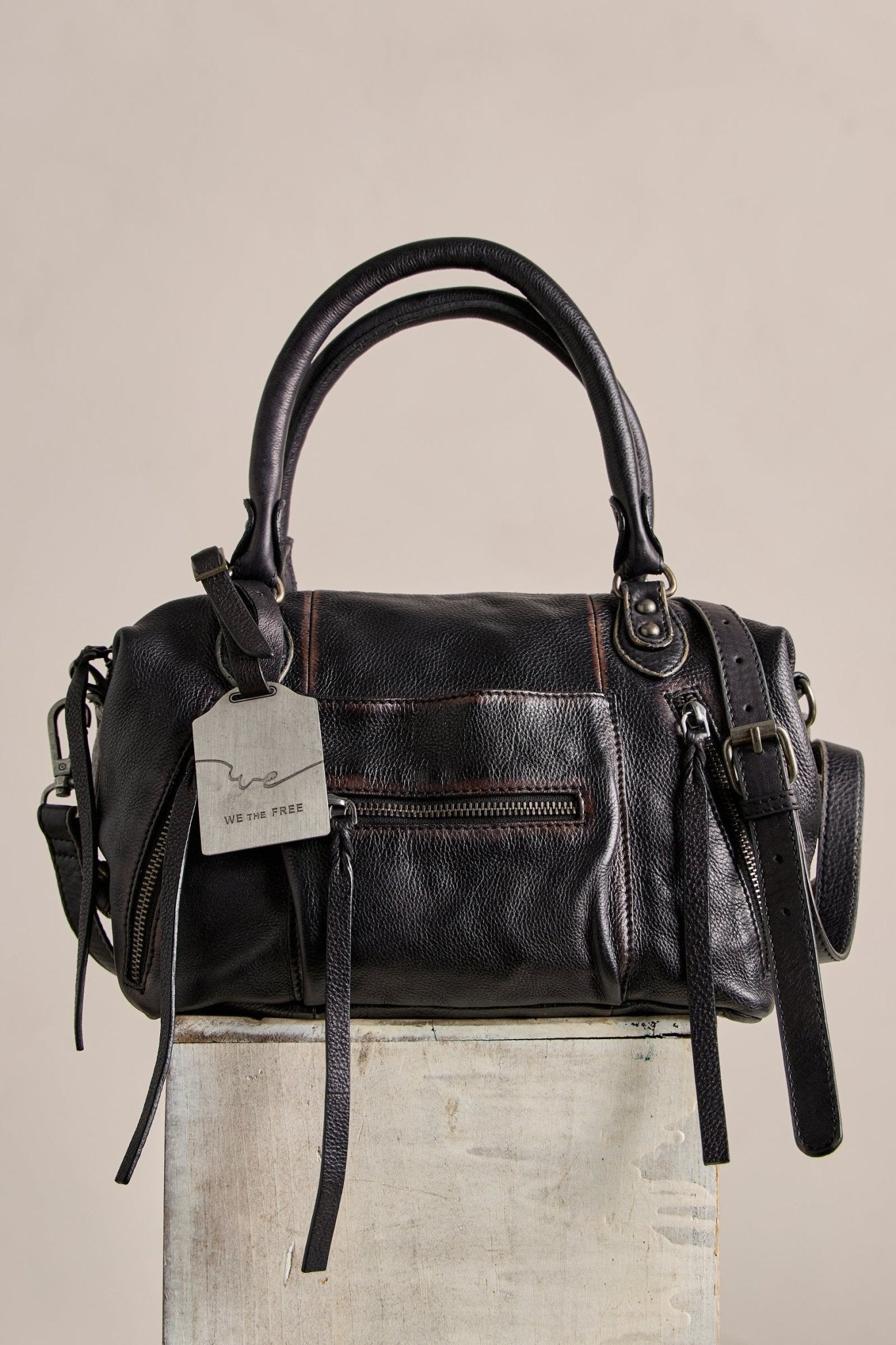 The Free People Baby Emerson Tote Bag in black, with double handles and front zip pockets, is perfect for vintage-inspired style lovers.