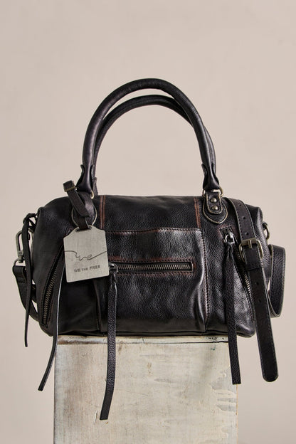 The Free People Baby Emerson Tote Bag in black, with double handles and front zip pockets, is perfect for vintage-inspired style lovers.