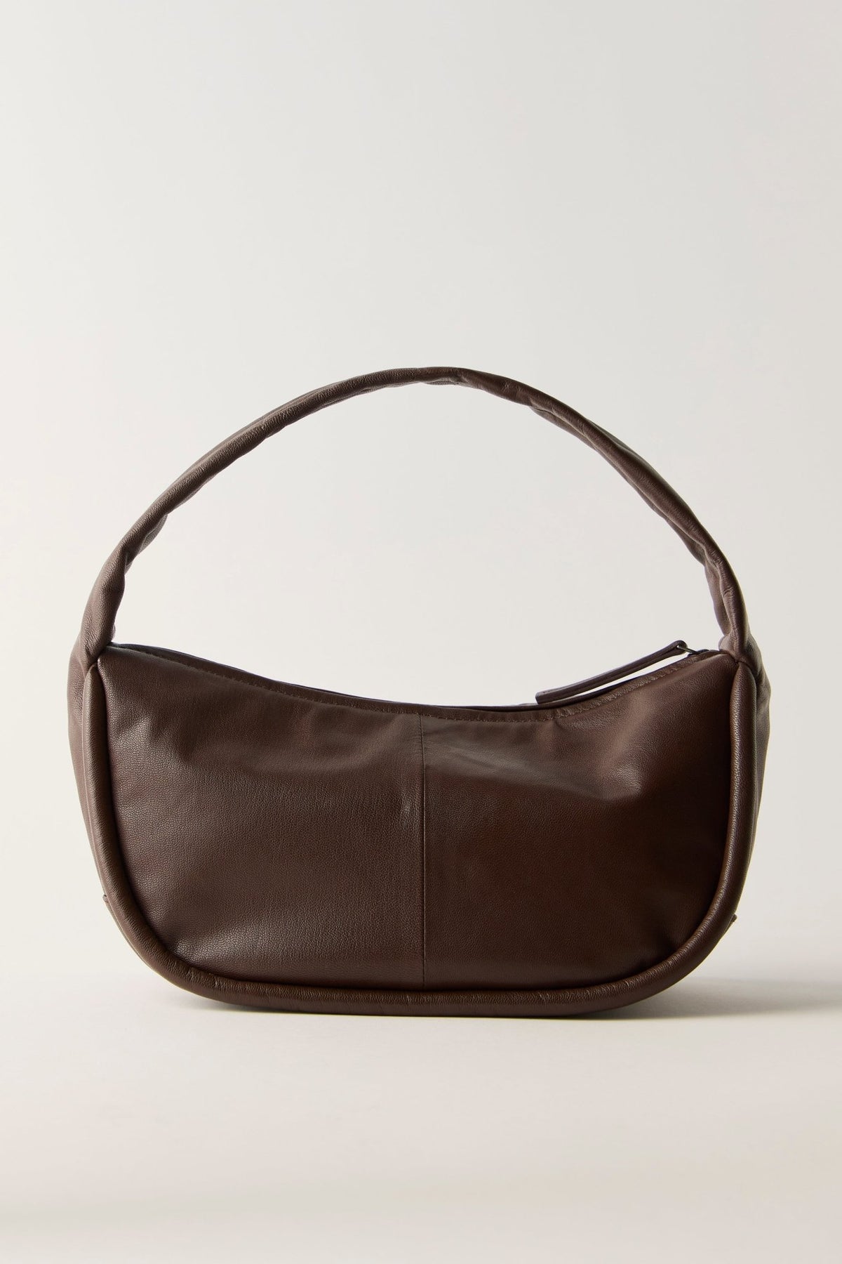 Dark brown crescent-shaped FREE PEOPLE ESPRESSO ALEXA SHOULDER BAG with a single handle and a top zipper closure.