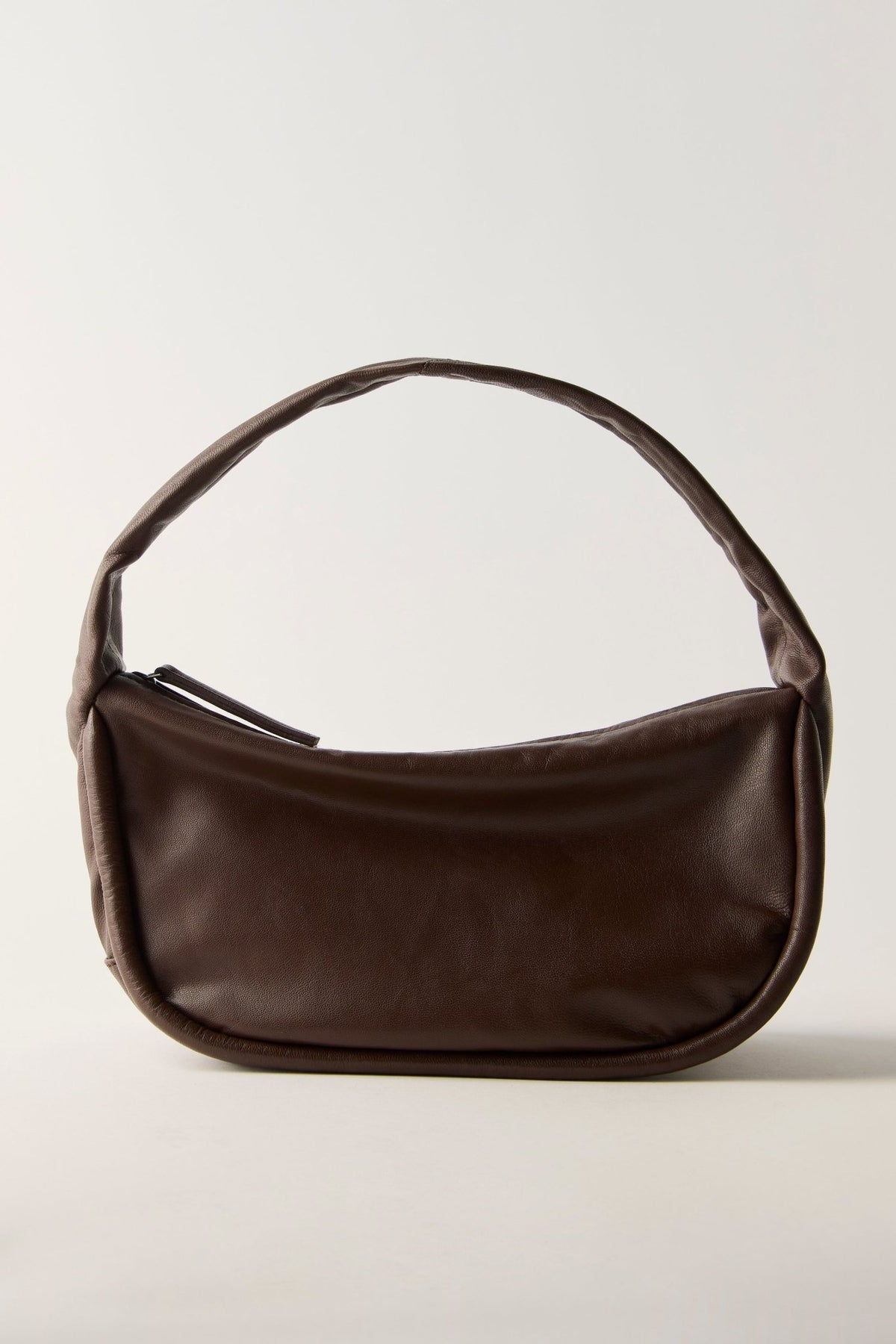 FREE PEOPLE ESPRESSO ALEXA SHOULDER BAG in dark brown leather with a curved silhouette and a single handle.