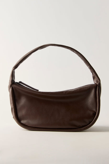 FREE PEOPLE ESPRESSO ALEXA SHOULDER BAG in dark brown leather with a curved silhouette and a single handle.