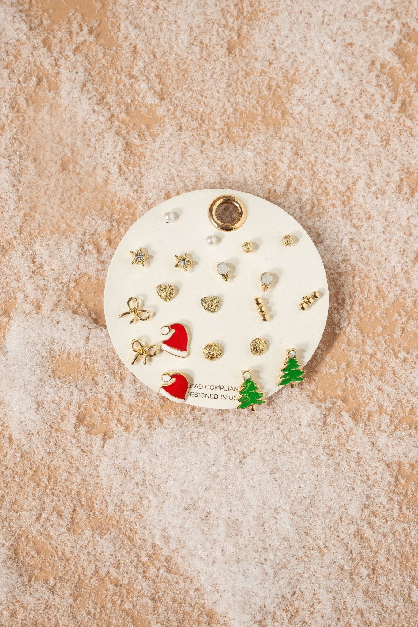 The Gold Assorted Christmas Stud Earrings Set features Santa hats, trees, pearls, and stars on a round card.