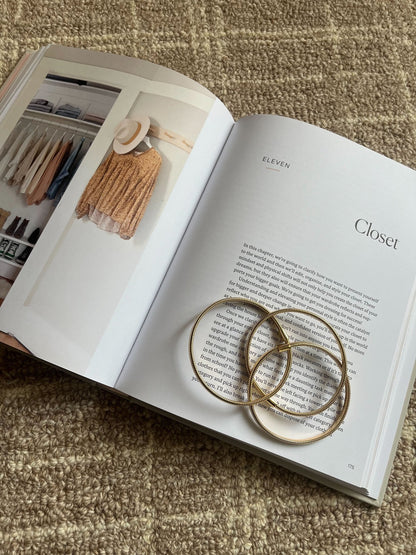 The Gold Coiled Metallic Bracelet Set adds a modern, elegant touch to any look.