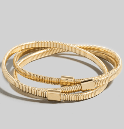 Gold Coiled Metallic Bracelet Set: Two textured, gold-toned coiled bracelets with cylindrical clasps on a light gray background.