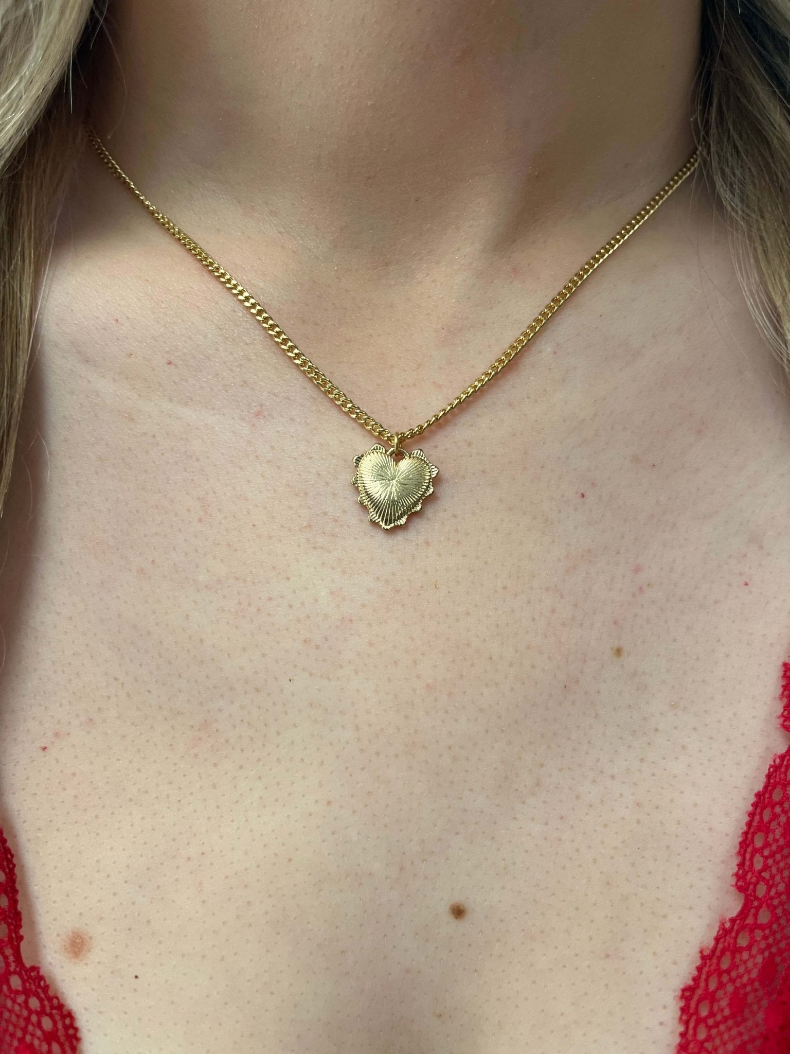 A person wearing a Gold Dipped Heart Pendant Necklace.