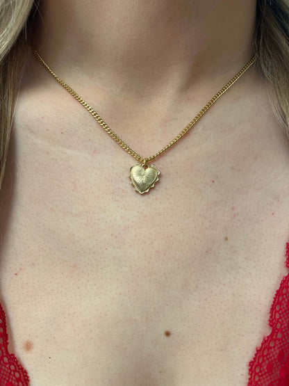 A person wearing a Gold Dipped Heart Pendant Necklace.