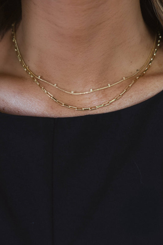 Close-up of a person wearing the Gold Dipped Mix Chain Necklace over a black top.