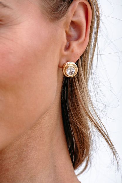 Close-up of a woman’s ear wearing Gold Dipped Oval Stud Earrings for an elegant, sparkling touch.