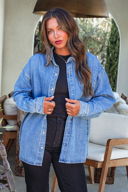 Woman with long brown hair wearing the Harvest Blues Denim Shacket—100% cotton, perfect fall layer for outdoor style.