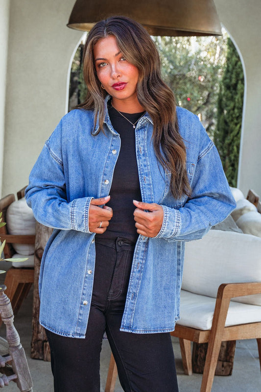 Woman with long brown hair wearing the Harvest Blues Denim Shacket—100% cotton, perfect fall layer for outdoor style.