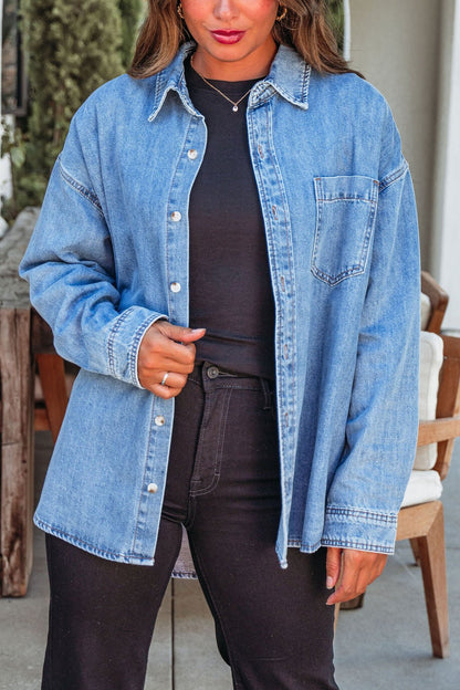A woman wears the Harvest Blues Denim Shacket, 100% cotton, over black clothes outdoors—a perfect fall layer.