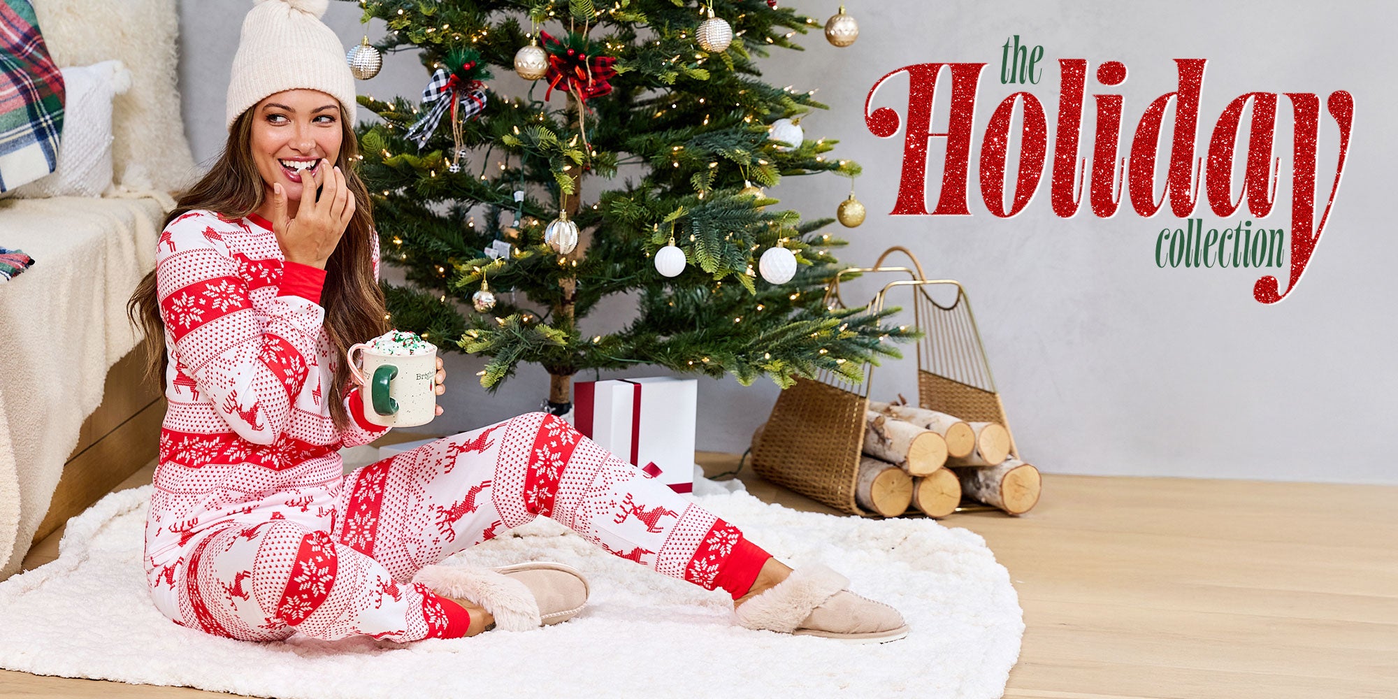 Woman in festive pajamas sitting on a couch with a Christmas tree and 'The Holiday Collection' text in the background.