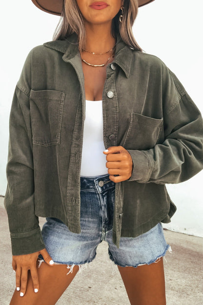 Woman in a Hunter Green Corduroy Shacket and denim shorts, outdoors—the perfect transitional layer for breezy days.