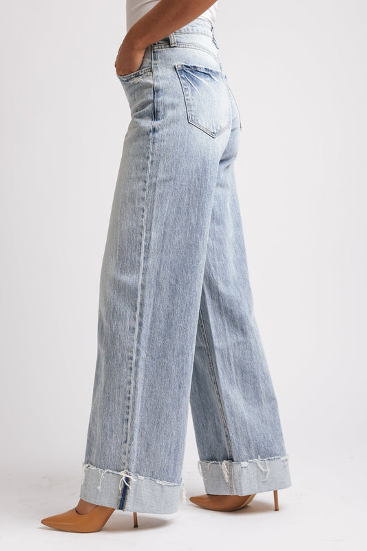 Model wears Light Wash Baggy Cuffed Wide Leg Jeans - FINAL SALE with frayed cuffs and tan heels against a plain background.