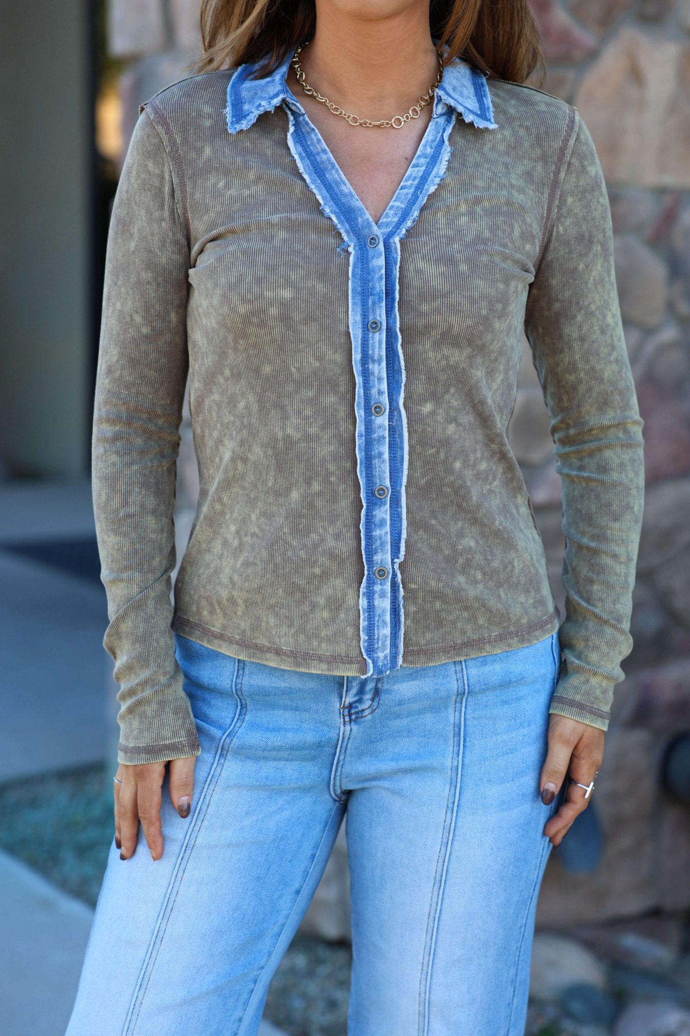 A woman wears a Light Wash Thermal Button Down Top with blue denim trim and light blue jeans, standing outdoors.