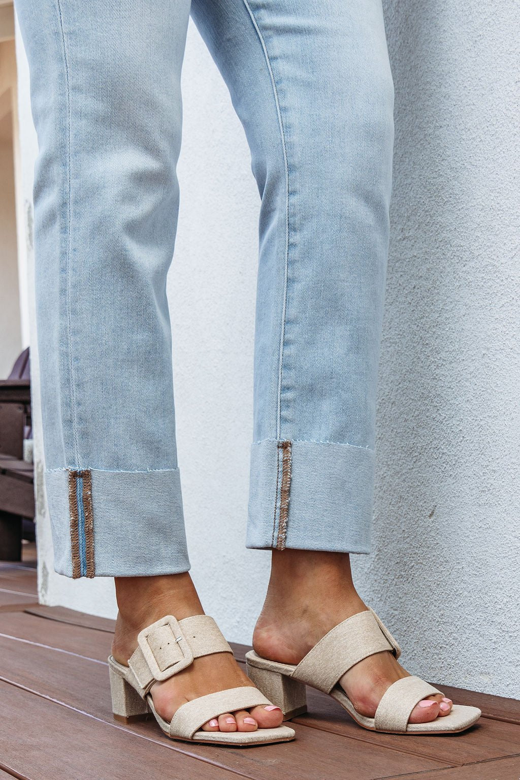 Person wearing light blue jeans and Matisse Lakelynn Natural Linen Block Heels, standing on a wooden floor.