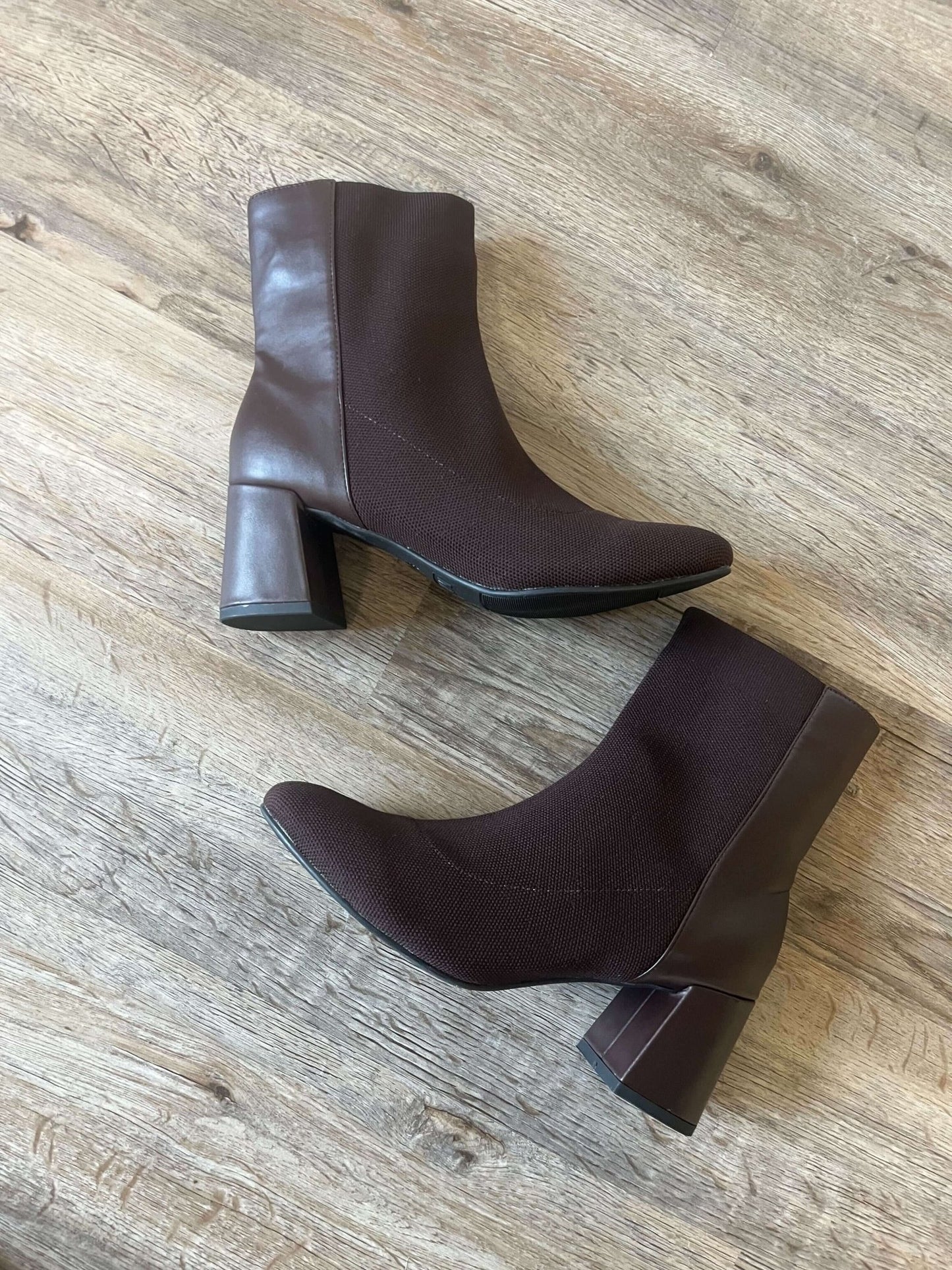 MIA Bronwen Brown Heeled Ankle Booties with textured fabric and leather accents, displayed on a wooden floor.