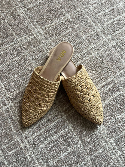 A pair of MIA Jany Natural Pointed Mules with a slip-on style sits on a textured, light-colored carpet.