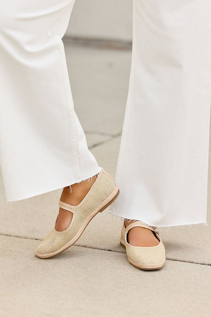 Individual in frayed white pants and MIA Monroe Ballet Flats - Natural, standing on a light concrete surface.
