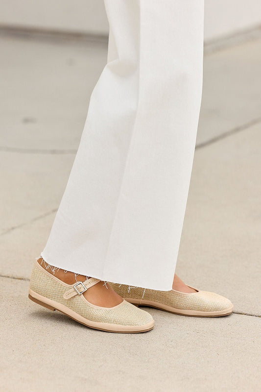 Person in white wide-leg pants and MIA Monroe Ballet Flats - Natural, standing on light pavement.