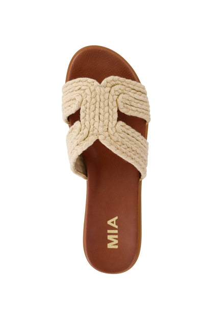 The MIA Poet Natural Woven Slide Sandals feature crisscross braided straps, a cushioned footbed, and gold MIA branding.