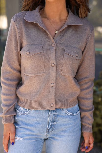 A woman wearing the Mocha Button Sweater Up Jacket.