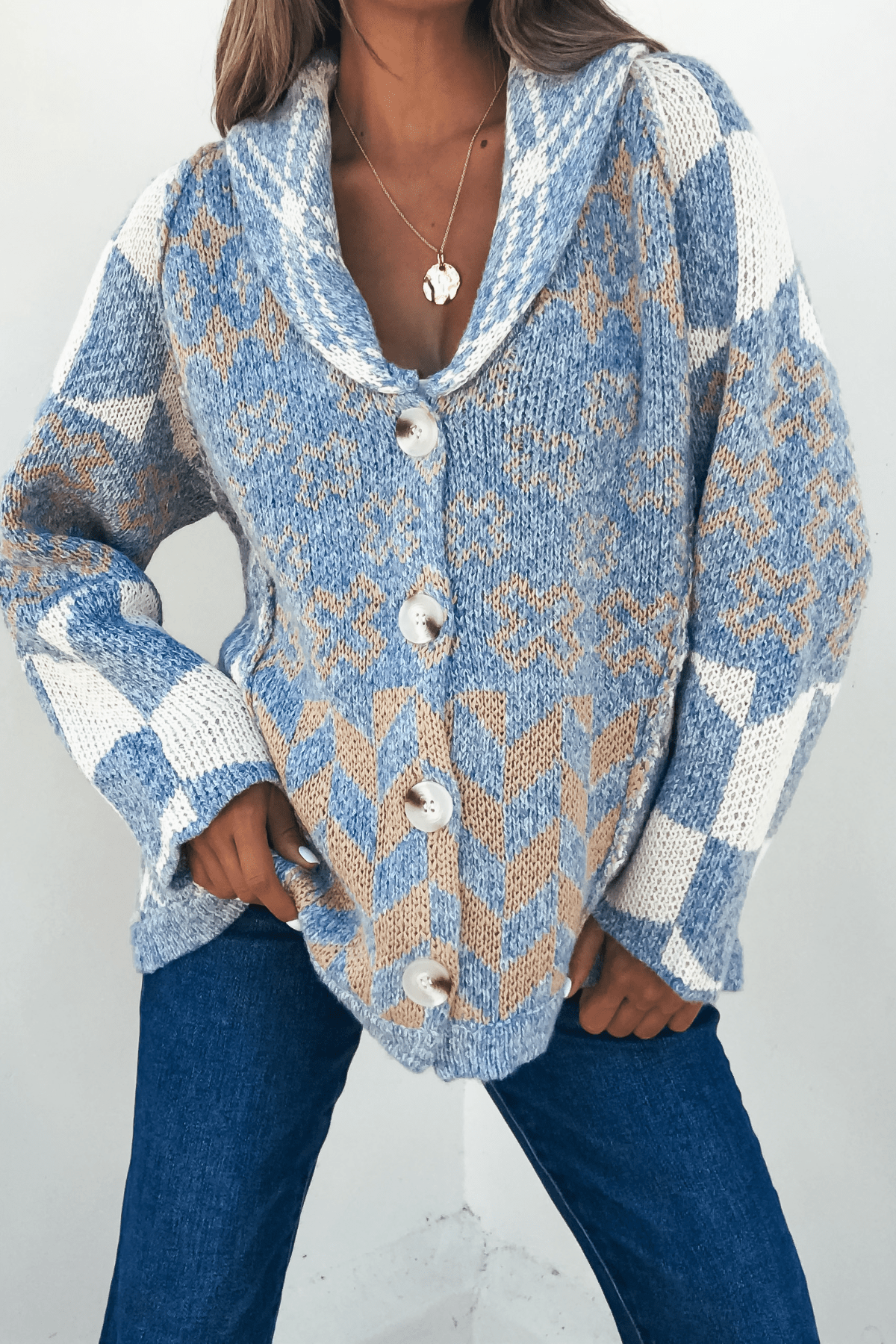 Woman models the Multi Blue Contrast Button Down Sweater Cardigan with blue jeans, posing with one hand on her hip.