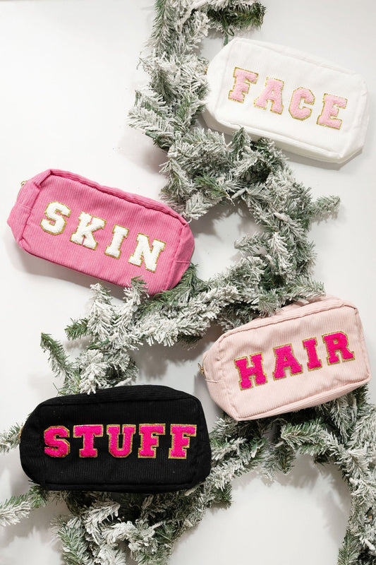 Four Multi Mix Patch Make Up Bags—labeled FACE, SKIN, HAIR, STUFF—rest on snow-dusted pine branches.