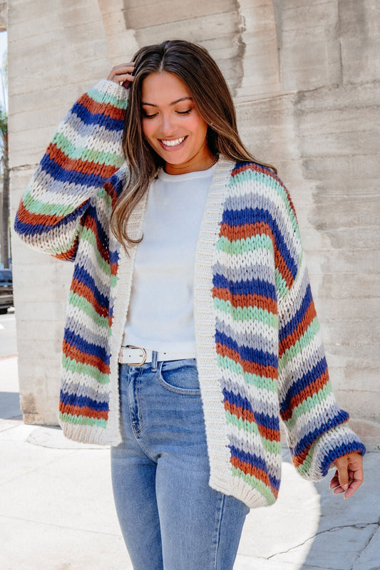 Woman smiles outdoors in a Multi Striped Open Front Sweater Cardigan—FINAL SALE, perfect for fall layering.