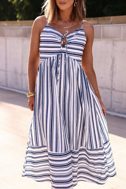Woman in a Navy and White Striped Tie Front Midi Dress, perfect for summer, standing outdoors in sunlight.