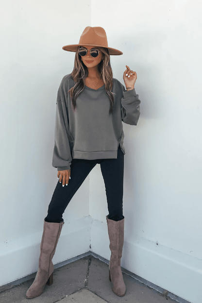 Woman wears an Olive Soft Cloud Scuba Top, an everyday essential in lightweight scuba fabric, with a tan hat and sunglasses.