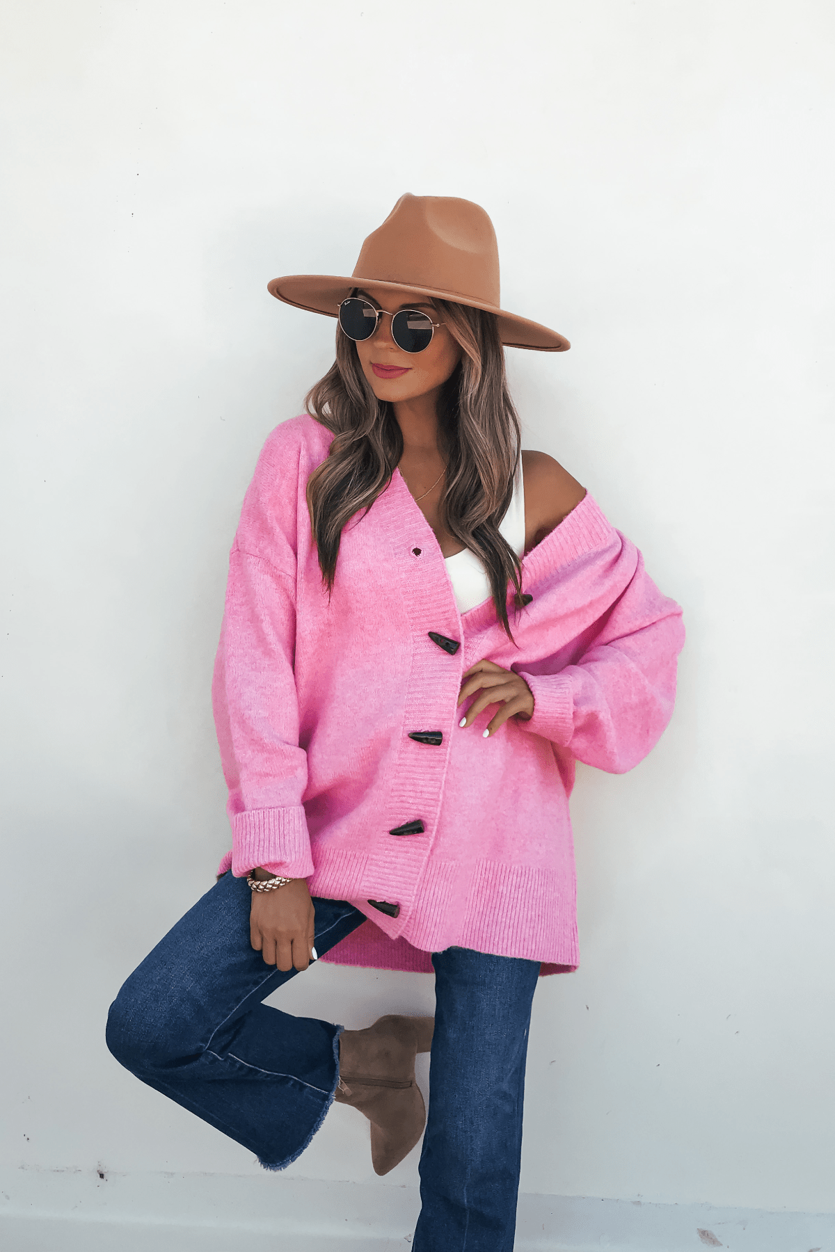 Woman in sunglasses and jeans models a Pink Brushed Button Down Sweater Cardigan—a cozy, chic fall look.