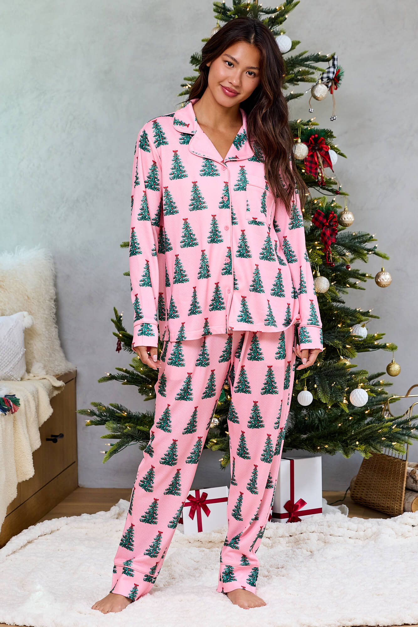 Barefoot woman by a decorated tree in the Pink Christmas Tree Print Pajama Set - FINAL SALE, a Magnolia exclusive.