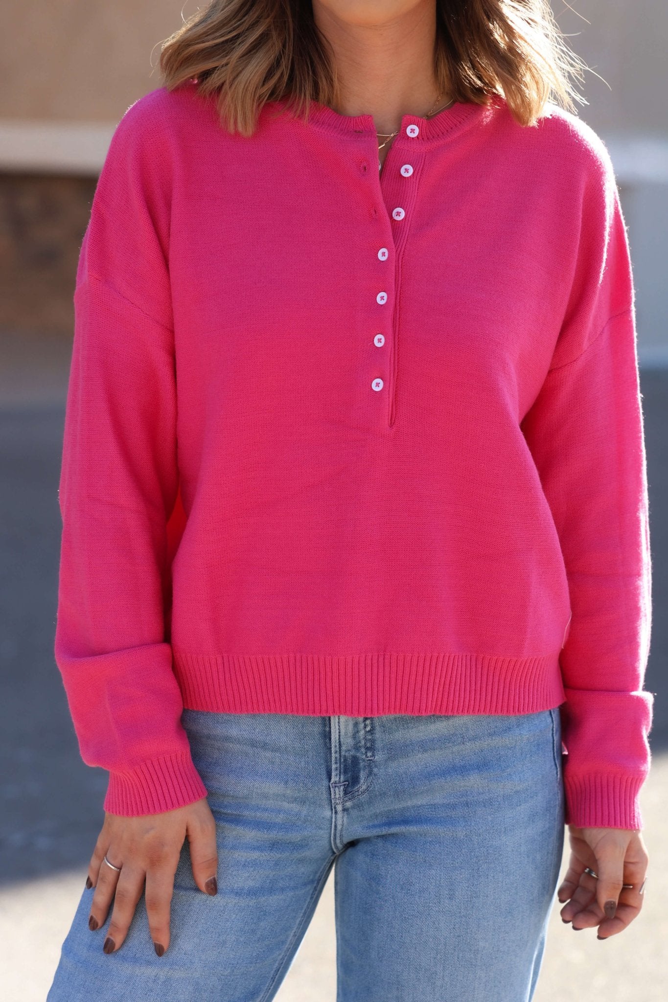 Wearing a Pink Henley Button Up Sweater with light blue jeans outdoors—this sweater is a true fall essential.