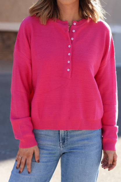 Wearing a Pink Henley Button Up Sweater with light blue jeans outdoors—this sweater is a true fall essential.