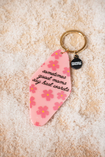 A fun gift, the Pink Sometimes Good Moms Say Bad Words Motel Keychain features a gold keyring and a small black tag.