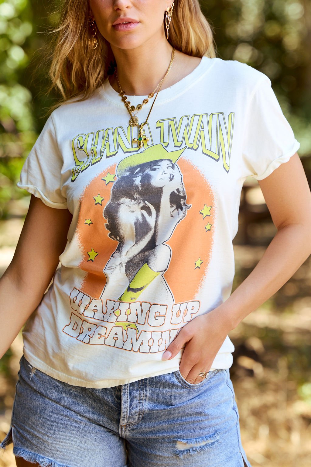 A woman wearing the Recycled Karma Cream Shania Twain Graphic Tee.