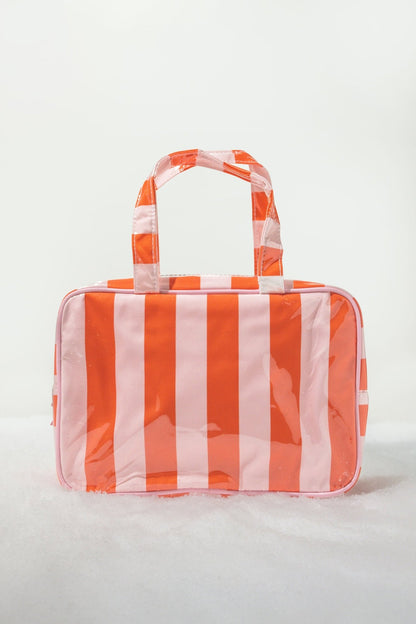 Red and pink striped travel cosmetic bag with handles; stylish, waterproof, and perfect as a tote or makeup organizer.