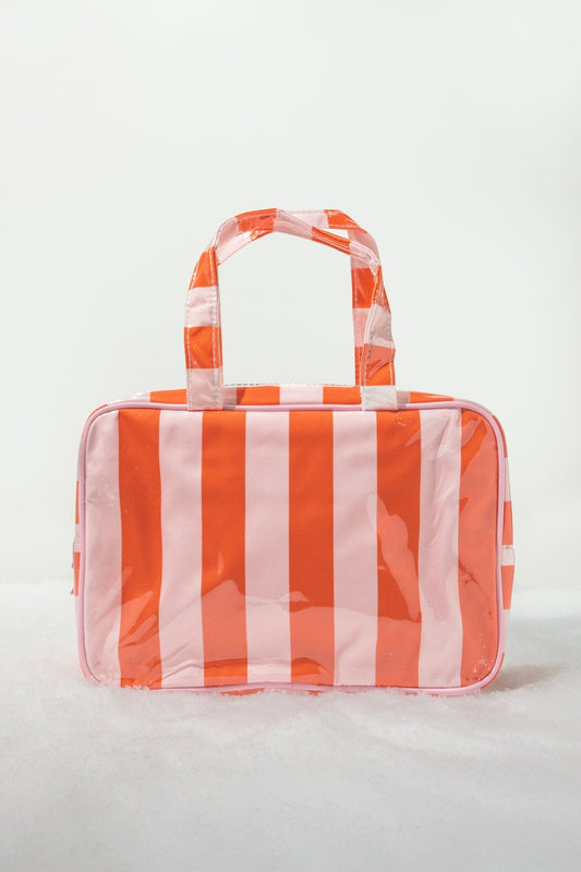 Red and pink striped travel cosmetic bag with handles; stylish, waterproof, and perfect as a tote or makeup organizer.