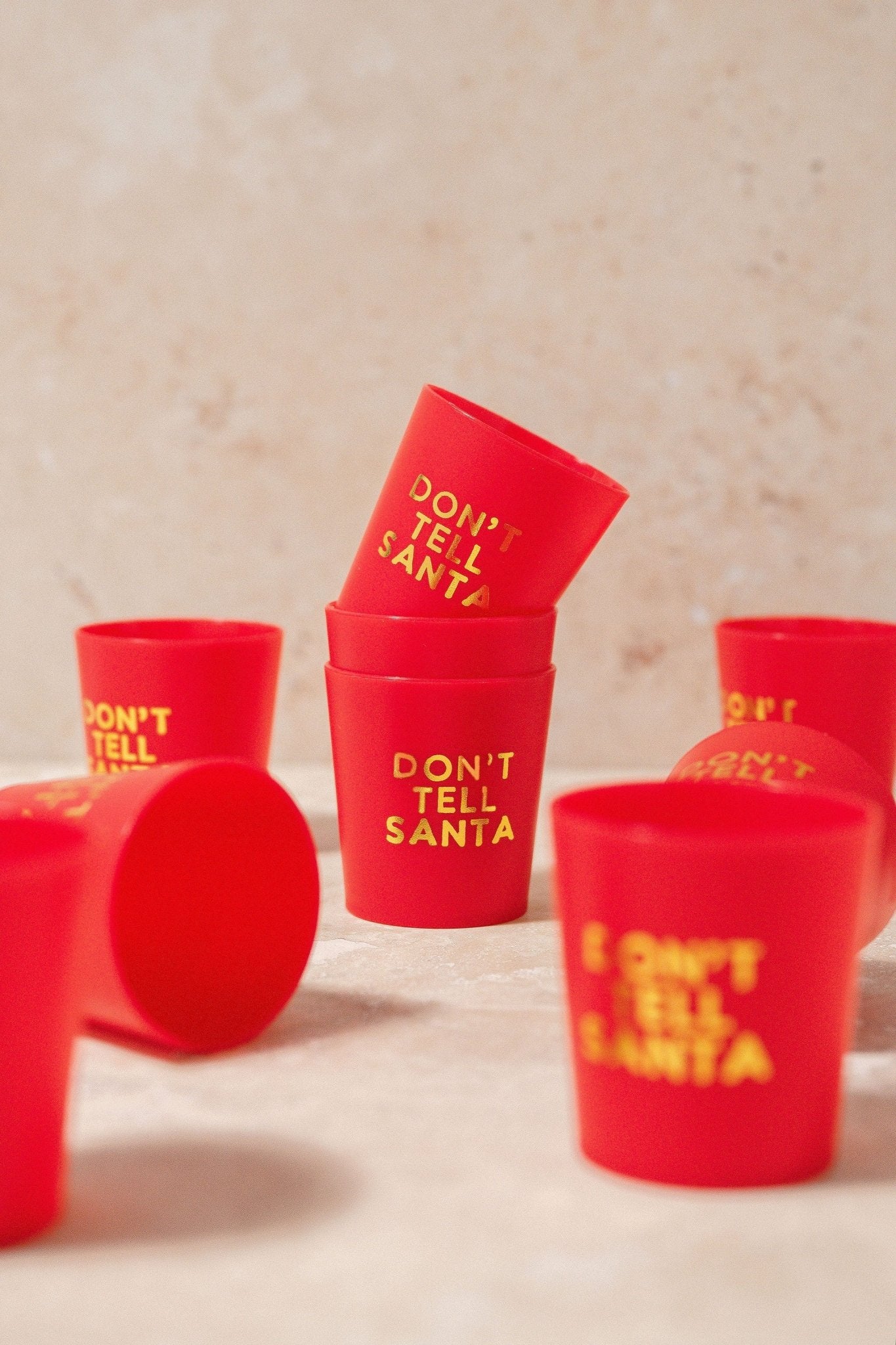 The Red Don't Tell Santa Shot Cup Set includes six festive cups, perfect for holiday parties or as stocking stuffer gifts.