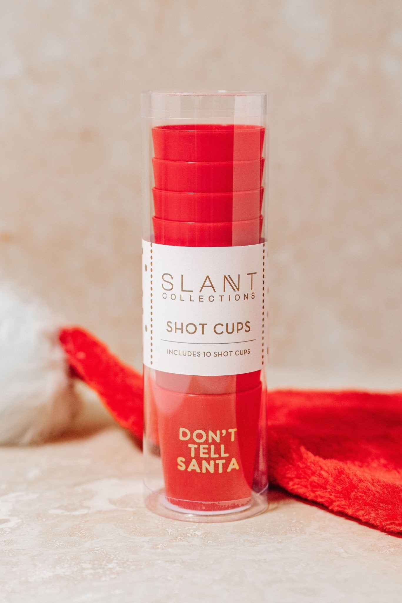 Red Don't Tell Santa Shot Cup Set in a clear container—perfect for your next holiday party stocking stuffer!.