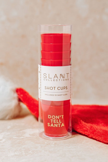 Red Don't Tell Santa Shot Cup Set in a clear container—perfect for your next holiday party stocking stuffer!.
