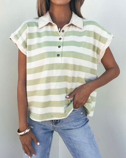 Woman wearing the Sage and Ivory Striped Button Up Shirt with a collared V-neckline, paired with light blue jeans.
