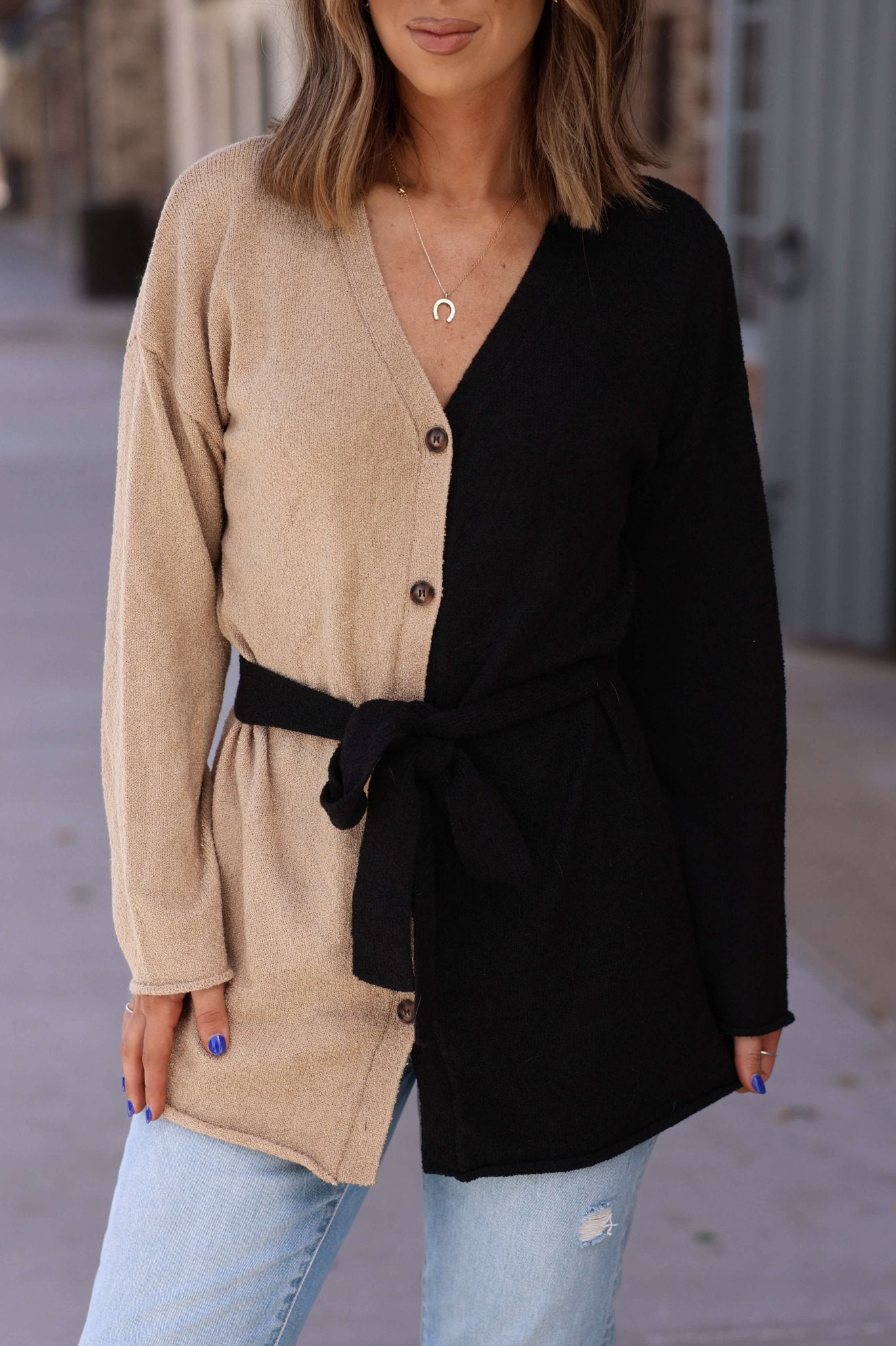 Woman in a Sand Color Block Button Down Cardigan—FINAL SALE—styled with light jeans and a crescent necklace for chic fall layering.