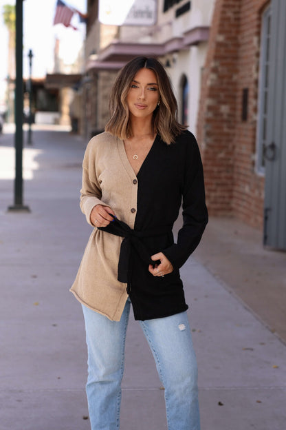 Woman stands on a sidewalk in the Sand Color Block Button Down Cardigan—perfect for effortless fall layering.