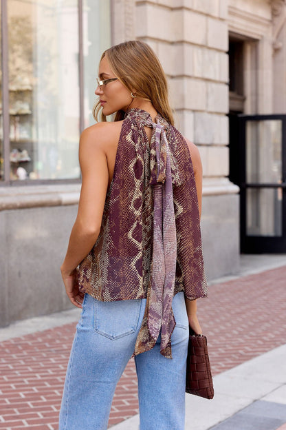 Woman with long hair in Steve Madden Alexane Top - Brown, light blue jeans, sunglasses, and holding a brown clutch on city sidewalk.