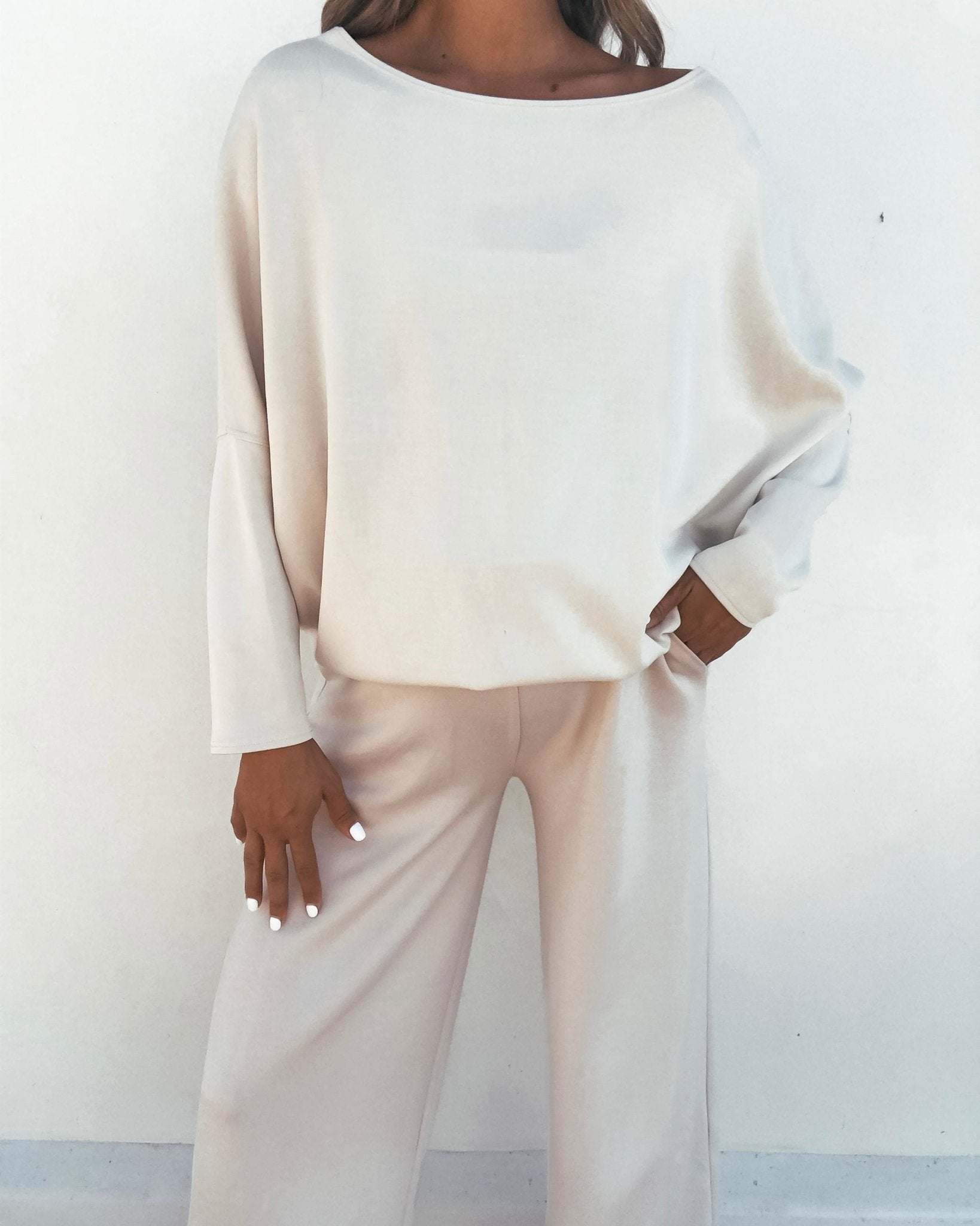 Person wearing the Stone Off The Shoulder Scuba Top and matching wide-leg pants, standing against a plain white background.