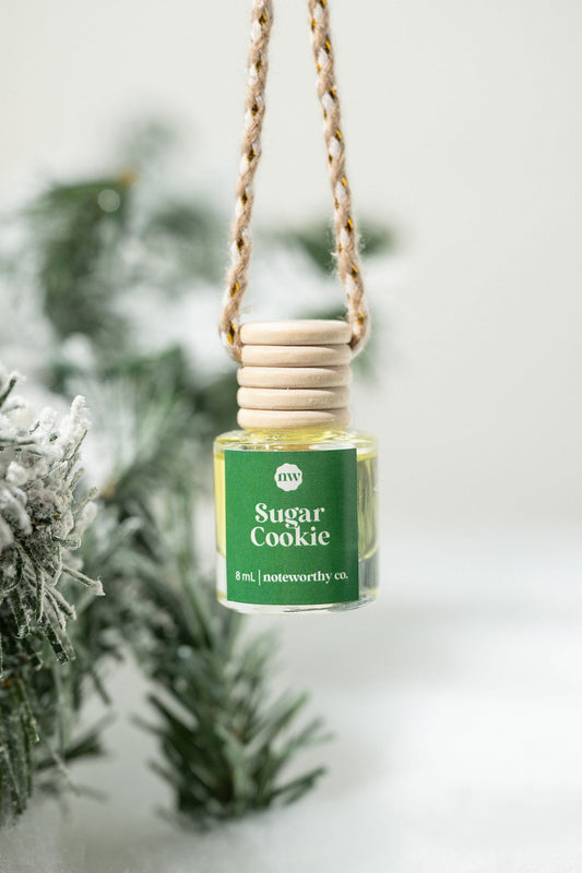 The Sugar Cookie Car Diffuser hangs on a braided cord—ideal as a festive Christmas gift.