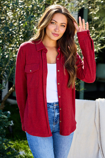 A woman in a relaxed fit wears the Thread and Supply Crimson Brushed Button Down Shirt – FINAL SALE, crafted from ultra-soft fabric.