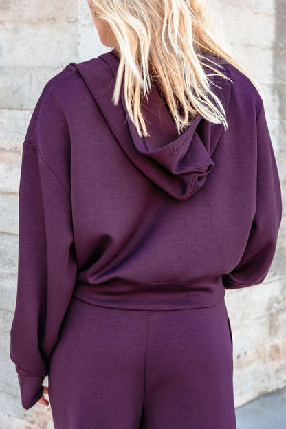 A person with blonde hair in a Vintage Havana Merlot Cloud Fleece Zip Up Hoodie, seen from the back.